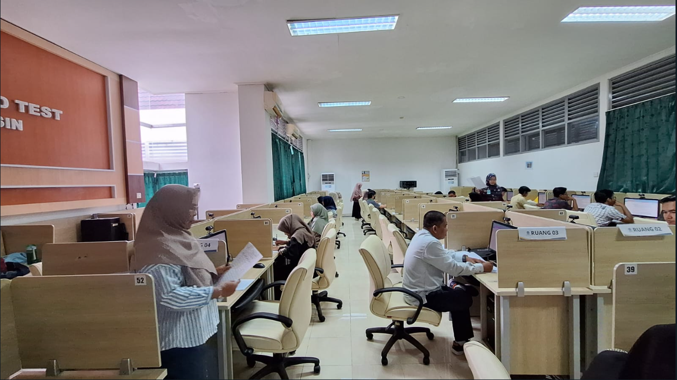 People in a room with computersDescription automatically generated